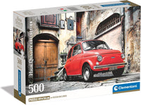 Caja del puzzle Coche Fiat Rojo de 500 piezas de Clementoni, con un Fiat 500 rojo aparcado en una calle empedrada de un casco antiguo italiano