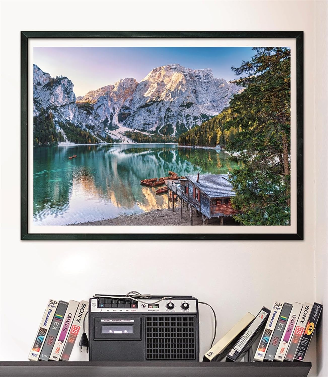 Puzzle Lago Esmeralda 1000 piezas Clementoni montado y enmarcado en marco negro sobre pared, sobre un estante con cintas VHS y radio-casete vintage