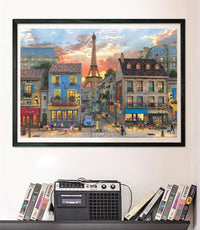 Puzzle Calle de París 1000 piezas Clementoni montado y enmarcado en negro sobre pared, sobre un estante con cintas VHS y radio-casete vintage